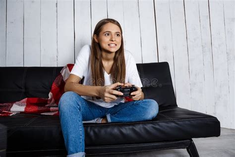 beautiful girl playing video games sitting on sofa at home stock image image of beauty