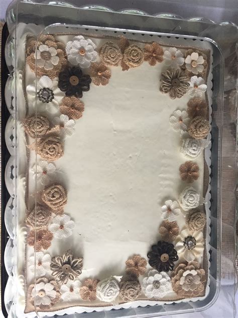 A Square Cake With White Frosting And Brown Flowers