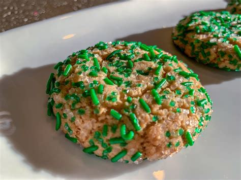 Two Cookies With Green Sprinkles On A White Plate