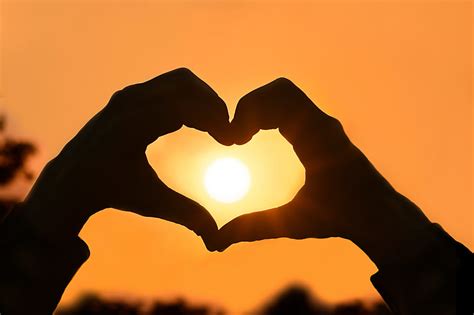 Royalty Free Photo Person Making A Heart Shape With Hands At Sunset