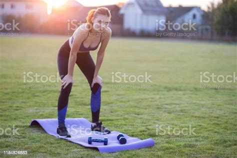Slim Blonde Girl Plays Sports And Performs Yoga Poses In Summer Grass