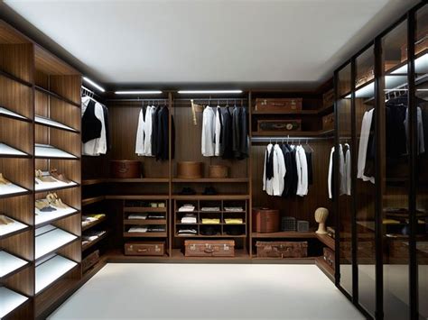 A Walk In Closet Filled With Lots Of Brown And White Clothing Hanging