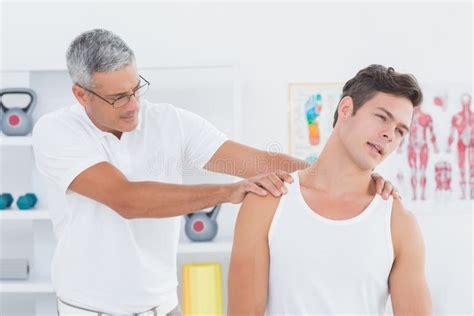 Doctor Examining His Patient Neck Stock Photo Image Of Caucasian