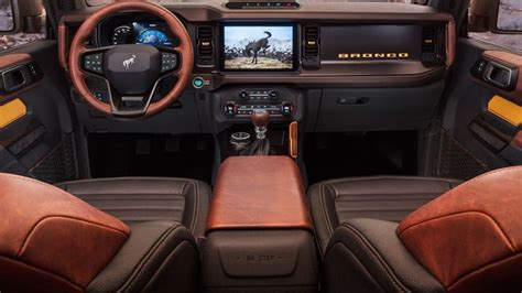 The Interior Of A Vehicle With Brown Leather Seats And Dash Board