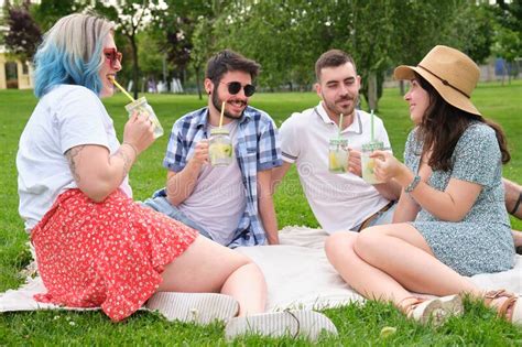 Group Of Happy Friends Talking And Drinking Refreshing Drinks In The