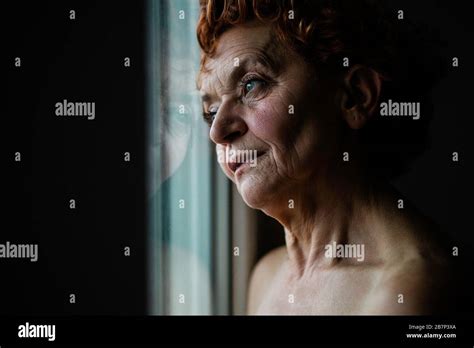 Mature Woman By The Window Thinking About Life Stock Photo Alamy