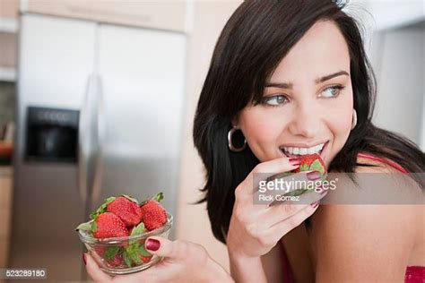 Young Woman Eating Strawberry Photos And Premium High Res Pictures Getty Images