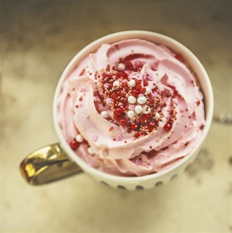 Close Up Of Cup With Hot Chocolate With Pink Whipped Cream And Red