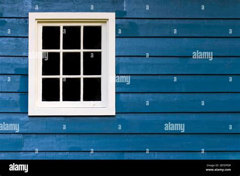 Multi Pane Window In A Blue Wooden House Stock Photo Alamy