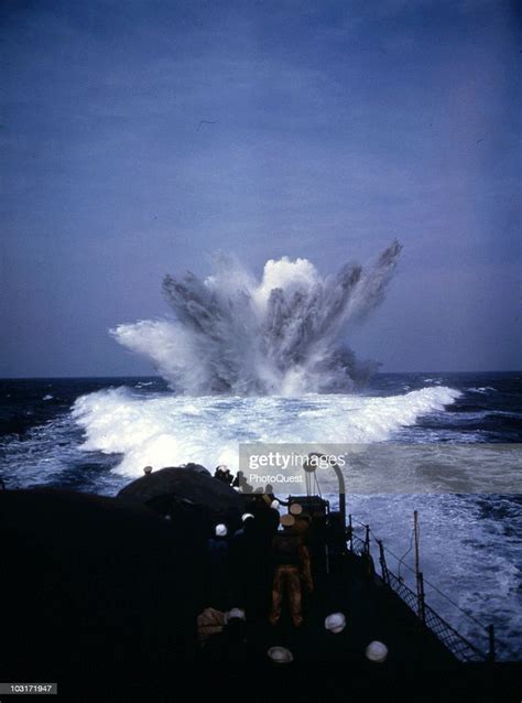 Sailors Stand On Deck And Watch As A Depth Charge Explodes In The