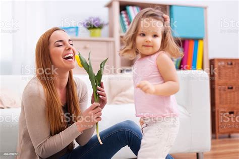 Beautiful Mother Enjoying The Flower Which She Received From Daughter