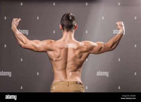Rear View Back Muscles Bodybuilder Young Adult Man Posing Arms Hands