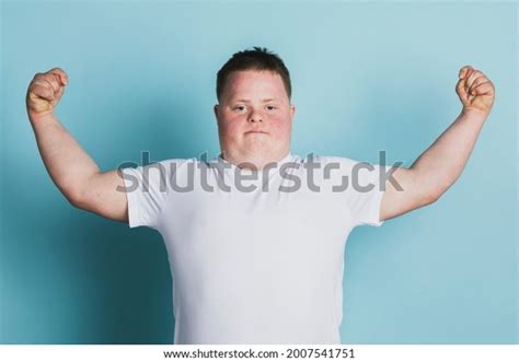 Стоковая фотография 2007541751 Proud Boy Down Syndrome Flexing His