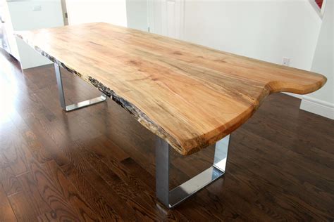 Simple, modern design meets rustic, natural style in this large rectangular live edge wood bench table handcrafted in india, the live edge wood table top is secured to wide, flat, black iron legs positioned in a stylish geometric pattern. Modern live edge maple table with sleek chrome base