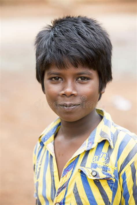 Poor Indian Boy With A Sad And Serious Eyes Looks At The Camera