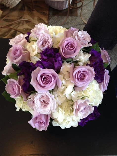 bridal bouquet done with lavender and light pink roses purple double lisianthus and white