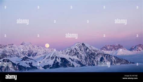 Full Moon Rise Over Enchanting Winter Mountain Landscape In The Swiss