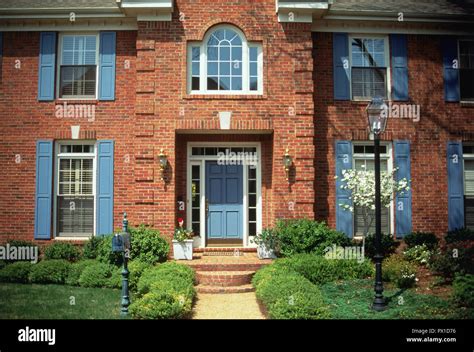 Red Brick Suburban Home With Blue Door And Shutters Memphis Tennessee