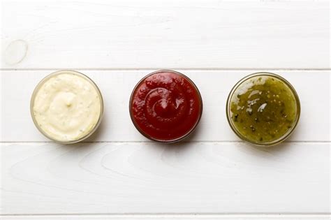 Premium Photo Different Types Of Sauces In Bowls On A Colored Board