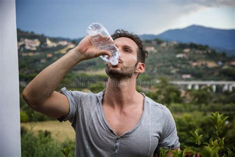 Handsome Man Drinking Water From Plastic Bottle Stock Photo Image Of