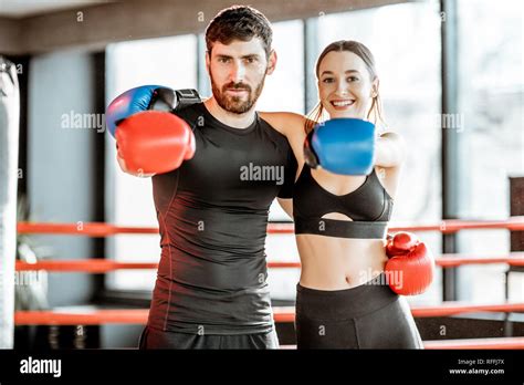 Portrait Of An Athletic Couple In Sportswear With Boxing Gloves Hugging