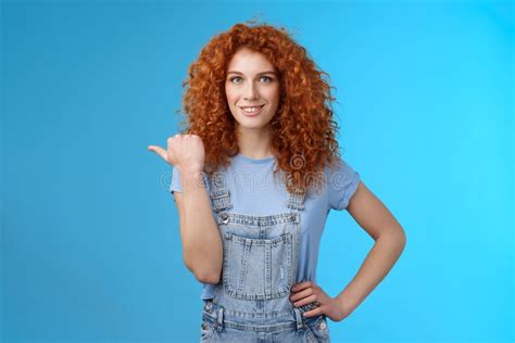 cheerful curious lively redhead good looking curly haired girl wearing summer overalls t shirt