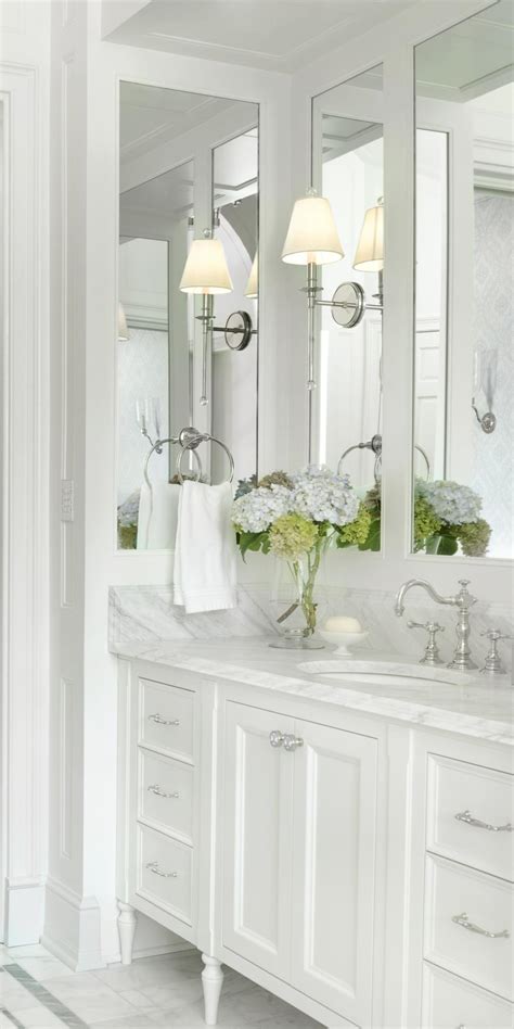 Spectacular master bathroom with white bathroom cabinets paired with calcutta marble. White Traditional Master Bathroom Vanity | HGTV