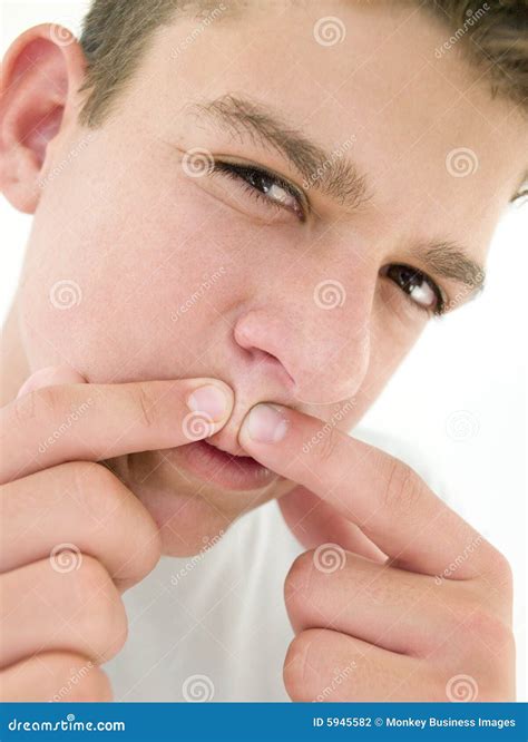 Teenage Boy Popping Zit on Face Stock Photo - Image of looking, shot