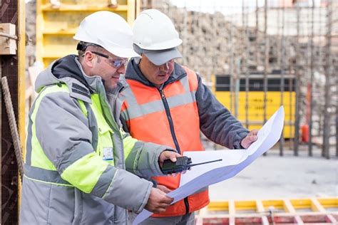 Civil Engineer And Foreman At Construction Site Stock Photo Download