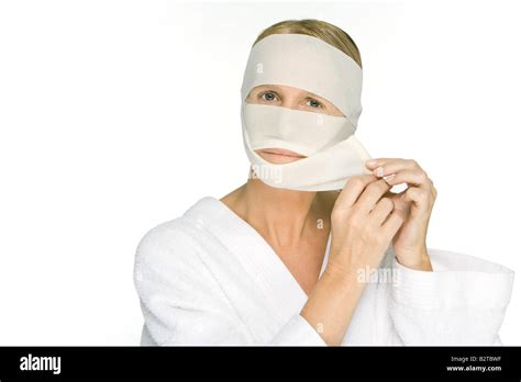 Woman Removing Bandages From Face Looking At Camera Stock Photo Alamy