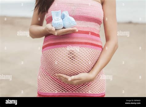 Pregnant Woman In White Bikini Posing On The Beach Stock Photo Alamy