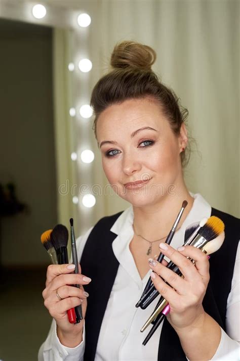 Professional Portrait Of Stylist And Makeup Artist With Brushes