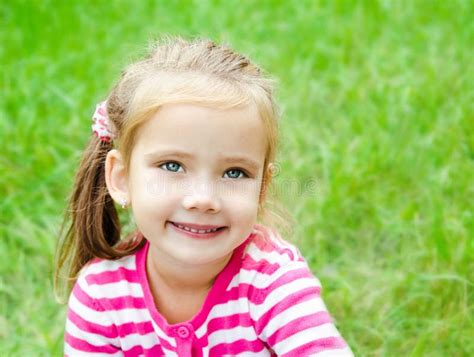Portrait Of Cute Smiling Little Girl On The Meadow Stock Photo Image