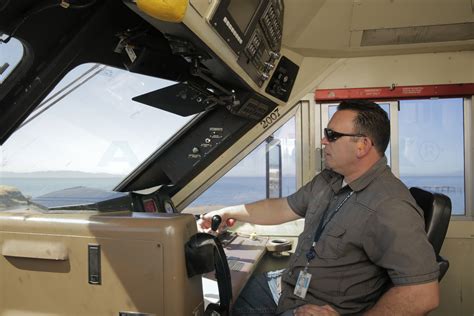 Locomotive engineer operating a Capitol Corridor train, 2015. — Amtrak