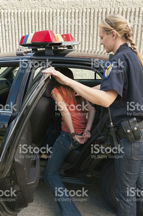 Female Cop Arresting Young Woman With Handcuffed Hands Behind Her Back