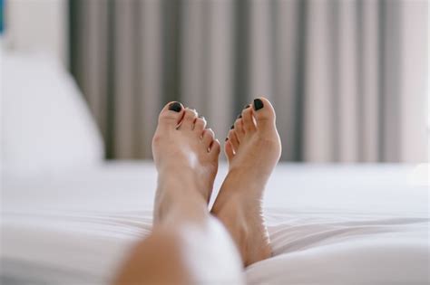 Premium Photo Closeup Image Of A Womans Feet On A White Bed