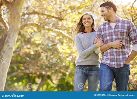 Romantic Couple Walking Through Autumn Woodland Stock Photo Image Of