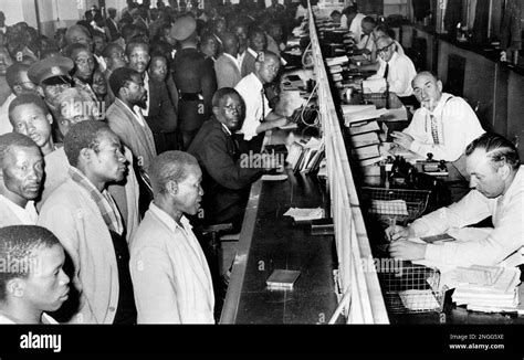 Black South Africans Line Up At The Counter At A Government Office To