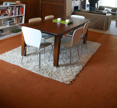 Rugs are a soft piece of furnishing that carpet the area under and around the table grounding it and the dining room chairs too. Carpet gives rich look to your home | Round dining room ...