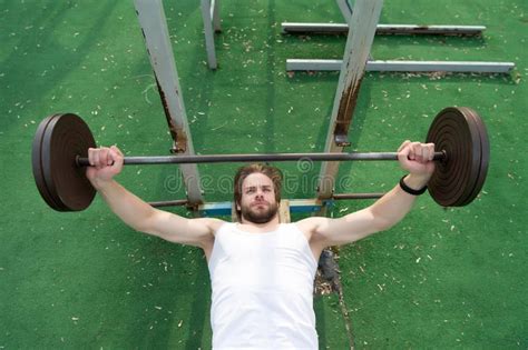 Muscular Man Workout In Gym Doing Exercises With Barbell Stock Image