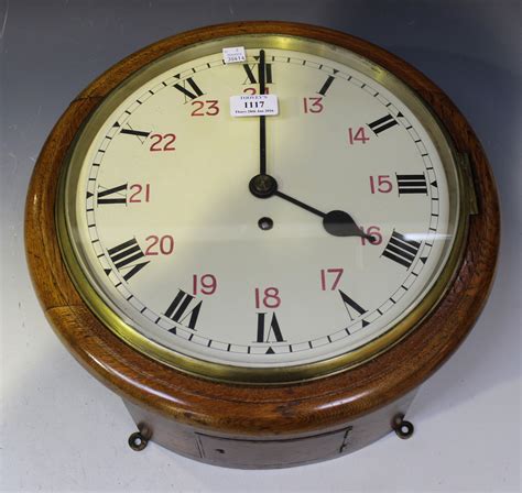 An Early 20th Century Oak Cased Circular Wall Timepiece With Single