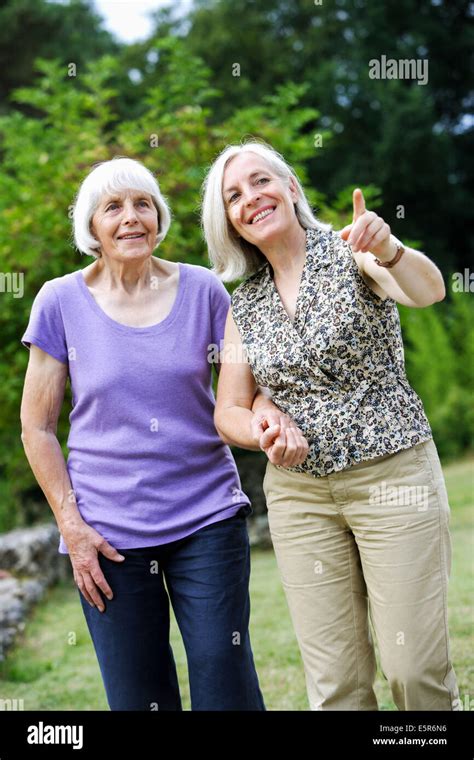 80 Year Old Woman With Her Daughter Going For A Walk Stock Photo Alamy