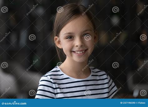 Headshot Portrait Of Adorable Smiling Preteen Girl Posing Indoors Stock