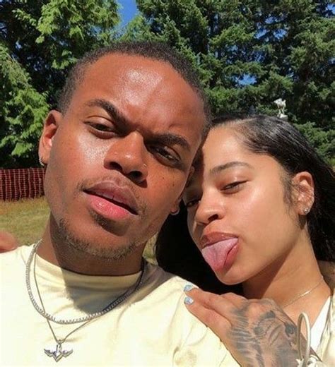 A Woman Sticking Her Tongue Out Next To A Man