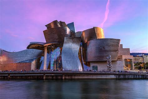 Mountain climber installing titanium facade panels during the construction of the guggenheim museum bilbao. Guggenheim Museum - Bilbao, Spain Photograph by Joana Kruse
