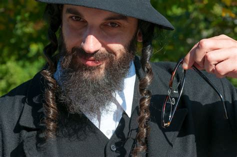 Portrait Of Young Orthodox Hasdim Jewish Man Holding Eyeglasses Stock