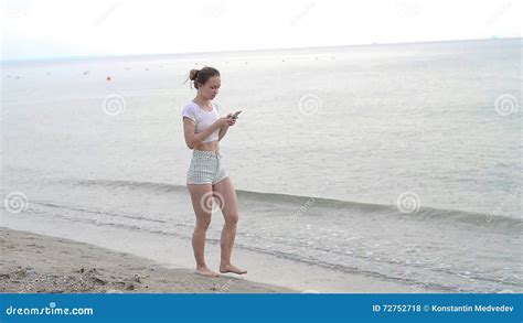 Sunbather Girl Wearing Bikini Using A Smart Phone On Summer Holidays On The Beach Stock Footage