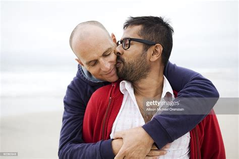 Two Men Kissing On Beach High Res Stock Photo Getty Images