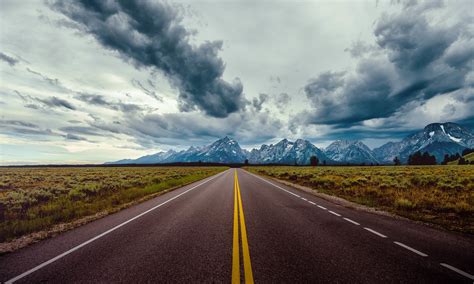 Download 5000x3000 Long Road Mountains Dark Clouds Scenic Wallpapers