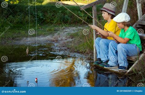 Happy Boys Go Fishing On The River Two Children Of The Fisher With A